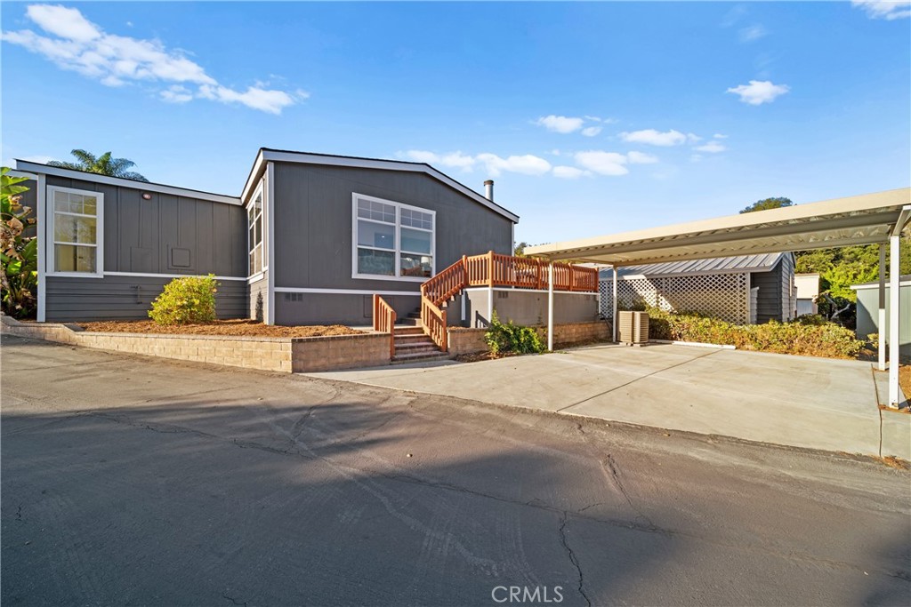 3909 Reche Road, Unit 60 Fallbrook, CA 92028 - Photo 29 of 37 a front view of a house with a yard and road