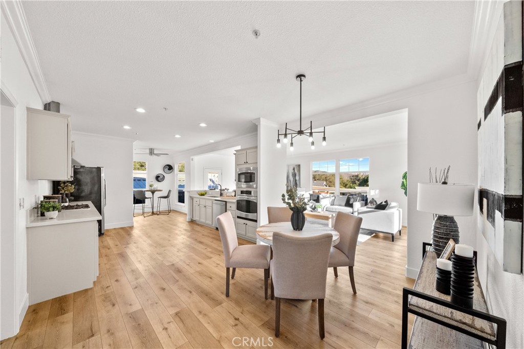 3909 Reche Road, Unit 60 Fallbrook, CA 92028 - Photo 3 of 37 a view of a dining room and livingroom with furniture wooden floor a chandelier