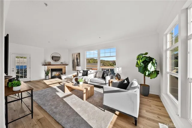 a living room with fireplace furniture and a large window