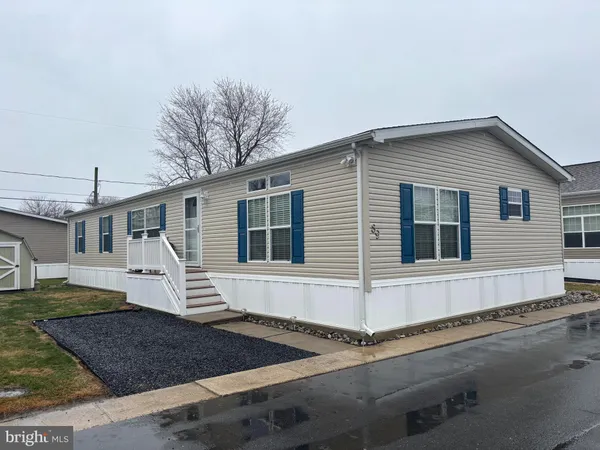 a view of a white house with large windows