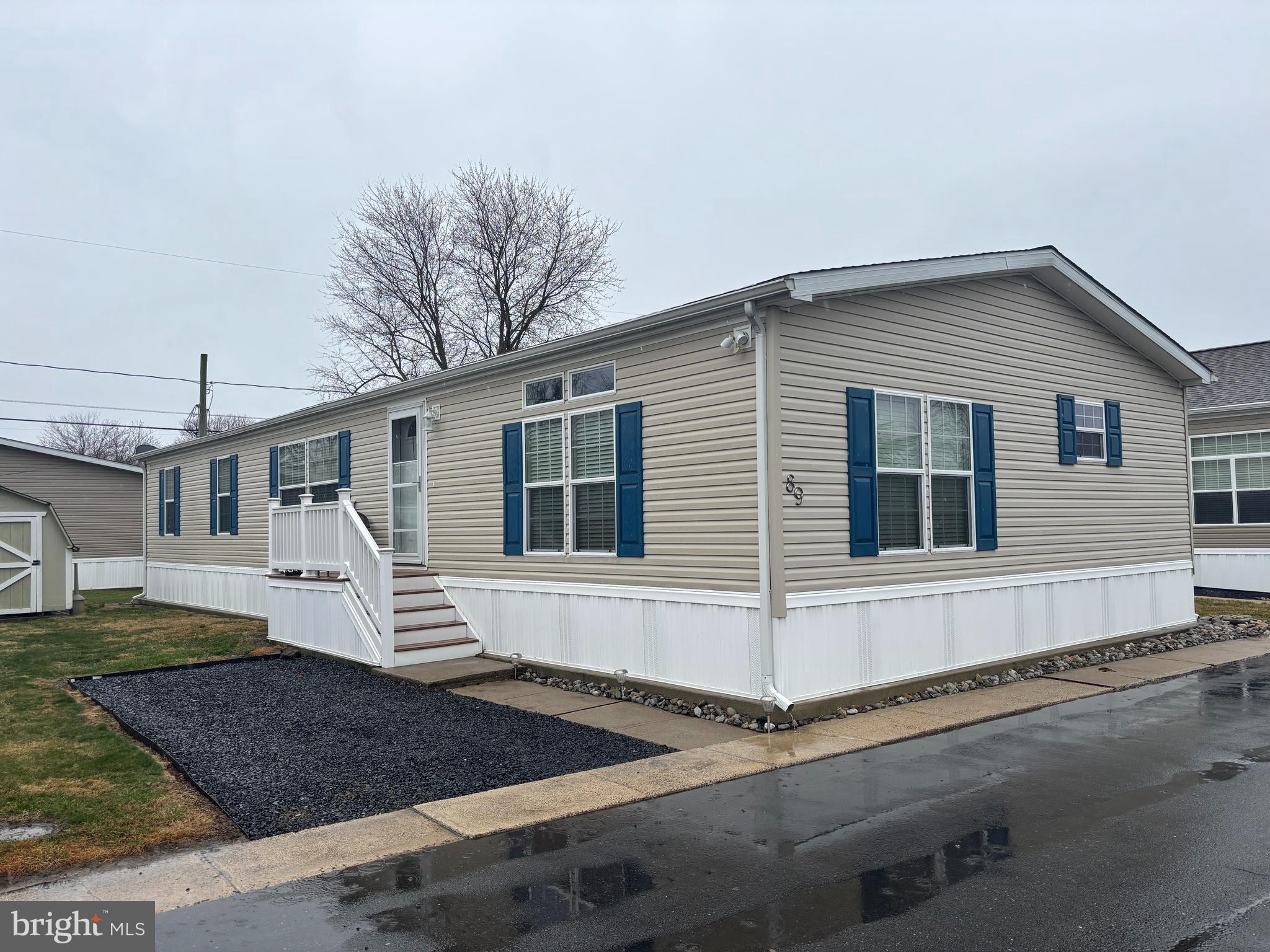 a view of a white house with large windows