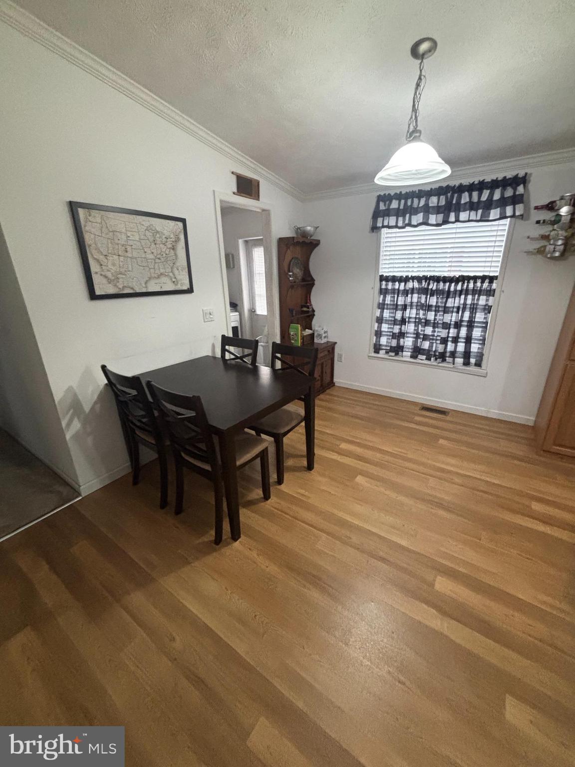 511 Sykesville Road, Unit 89 Wrightstown, NJ 08562 - Photo 2 of 12 a living room with furniture a table and a chandelier