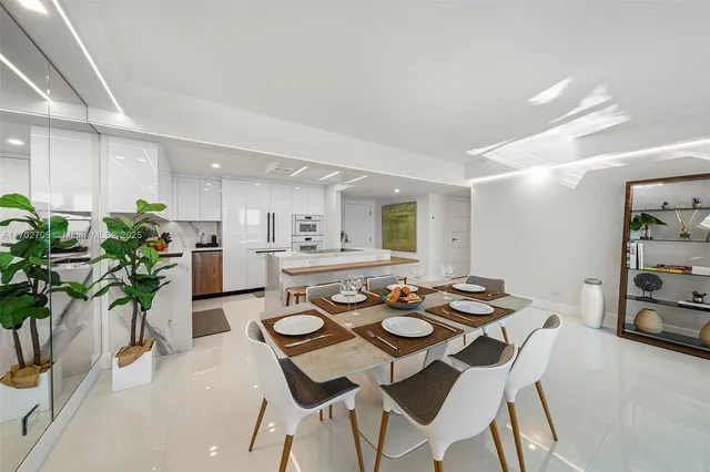 a view of a dining room with furniture and a potted plant