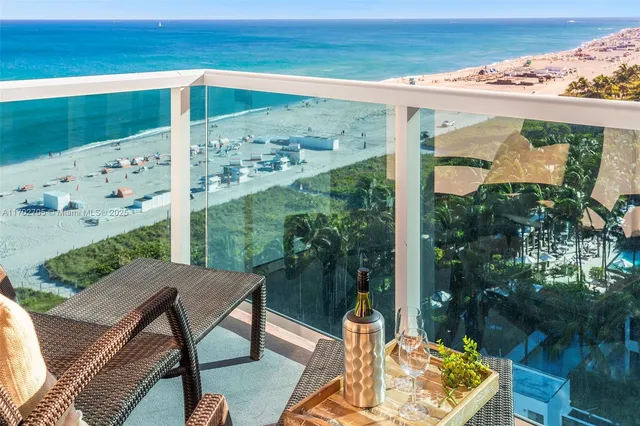 a balcony with table and chairs and wooden floor