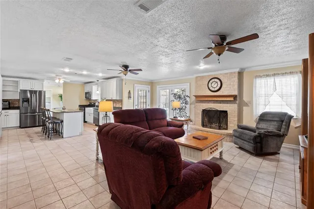 a living room with furniture a flat screen tv and a large window