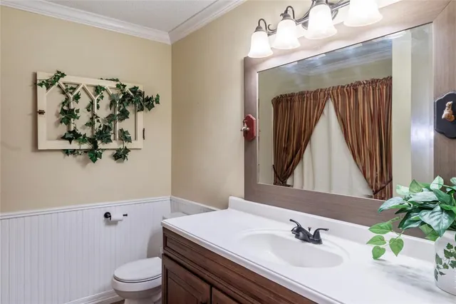 a room with furniture a potted plant and a chandelier