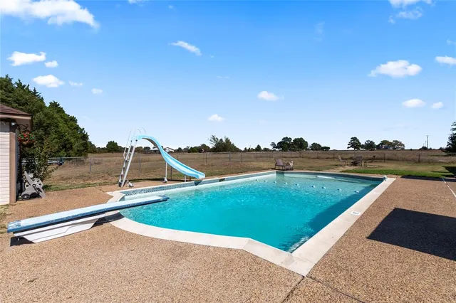 a view of a swimming pool with a yard