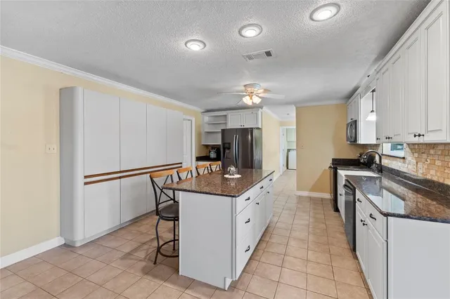 a living room with fireplace furniture and a floor to ceiling window