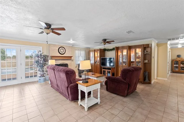 a living room with furniture a fireplace and a window