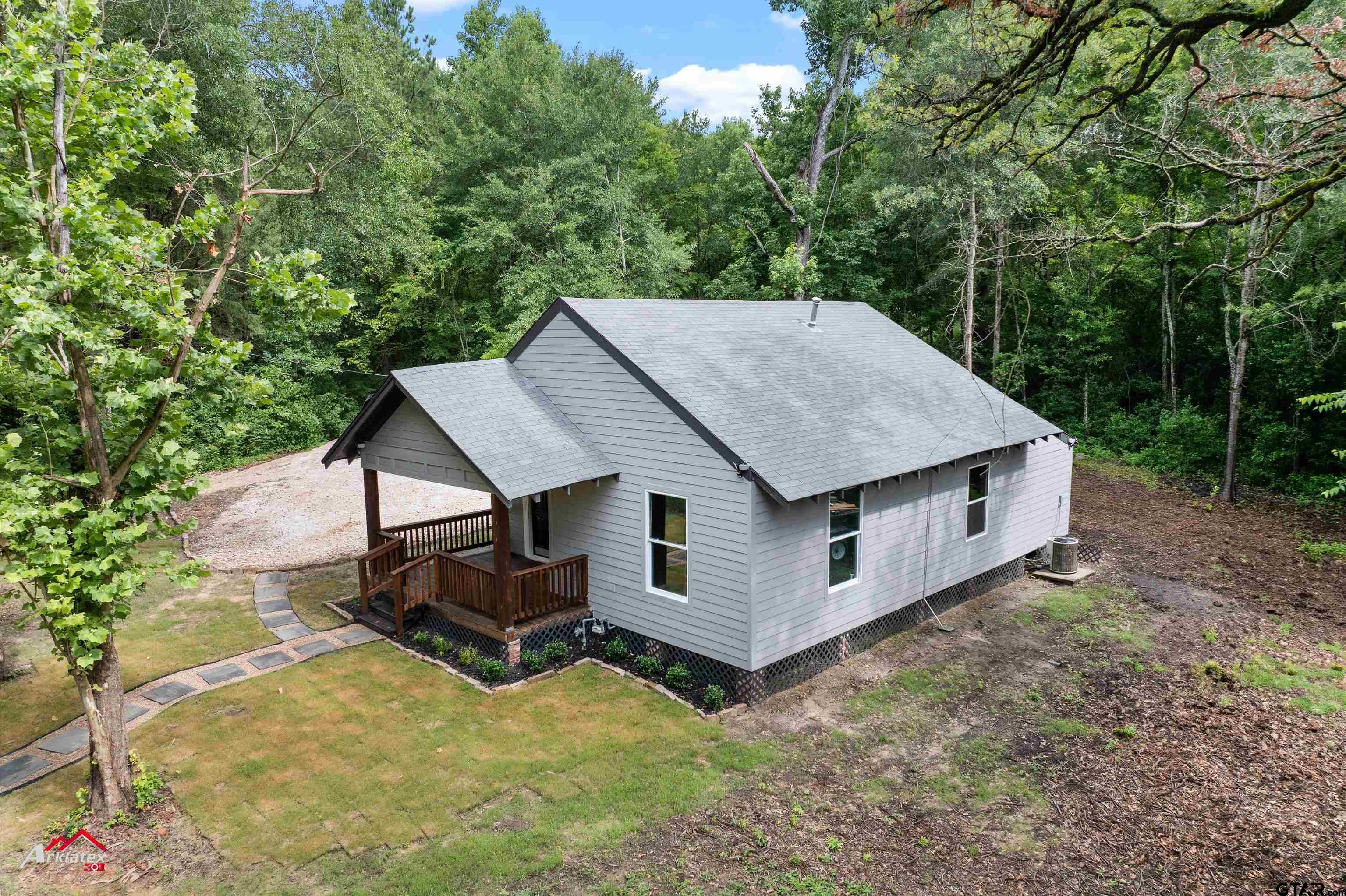 an aerial view of a house with yard porch and furniture
