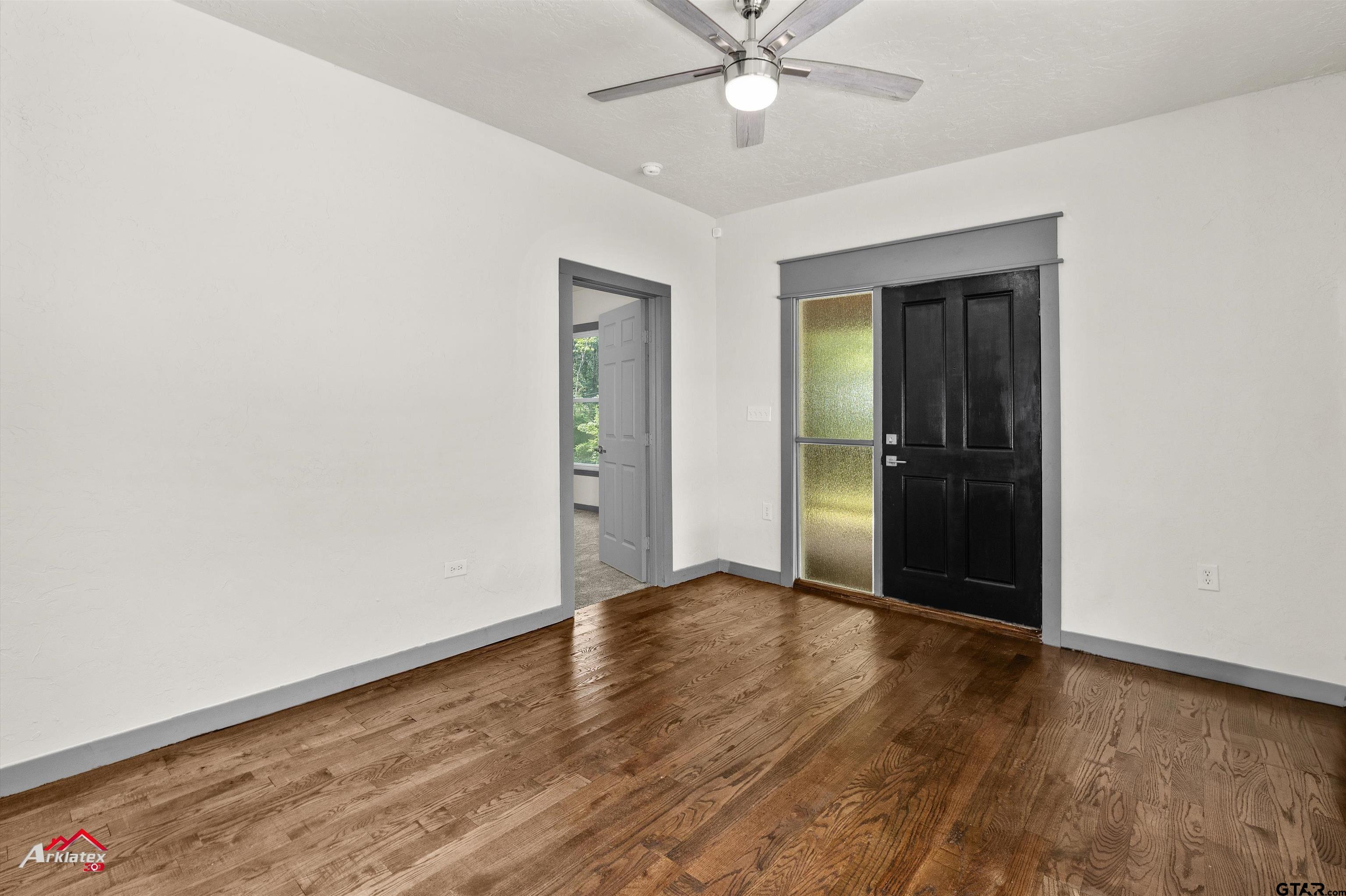 200 Jenkins Street Henderson, TX 75652 - Photo 13 of 25 an empty room with wooden floor closet and windows