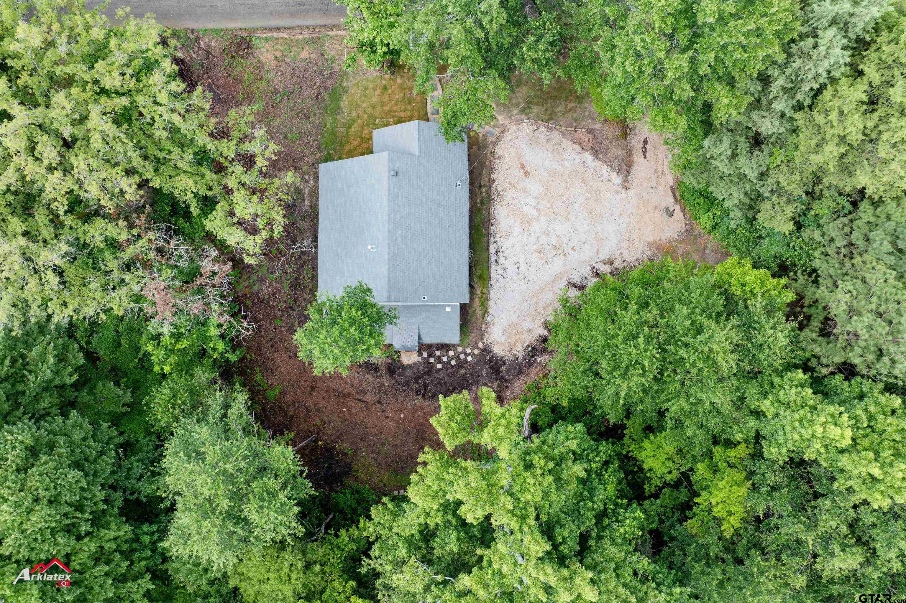 200 Jenkins Street Henderson, TX 75652 - Photo 6 of 25 an aerial view of a house with a yard and large trees