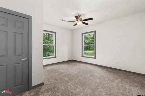 a view of room with window and ceiling fan