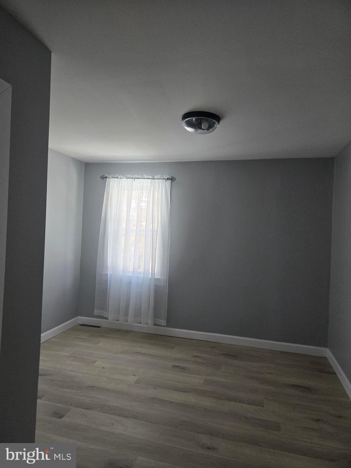 975 Williams Street Cumberland, MD 21502 - Photo 17 of 33 a view of an empty room with wooden floor and a window