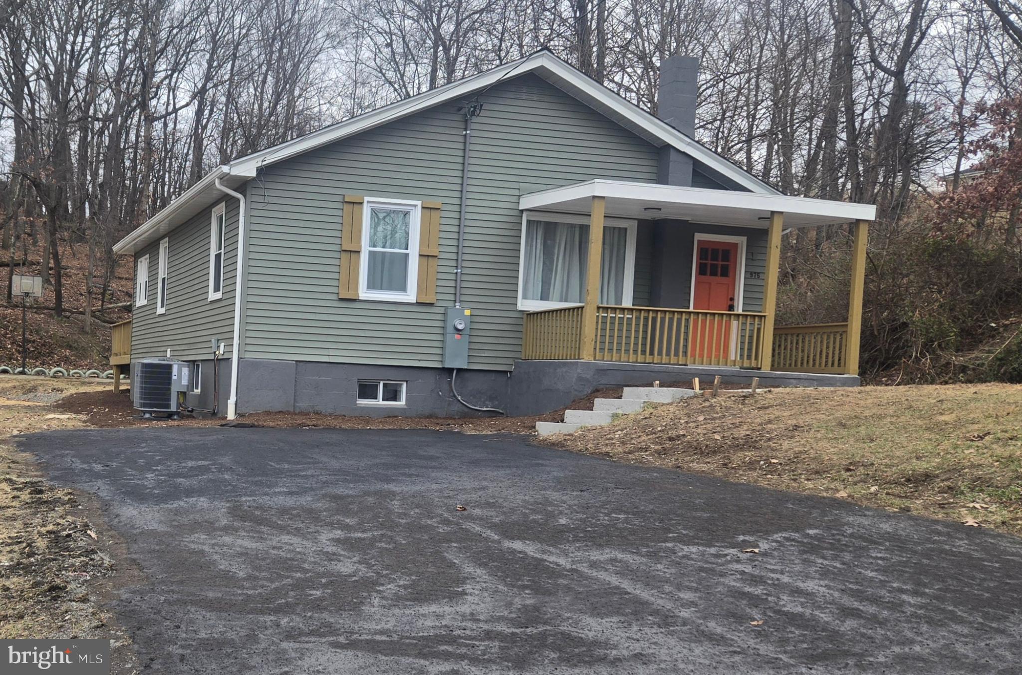 975 Williams Street Cumberland, MD 21502 - Photo 2 of 33 a front view of a house with a yard and garage