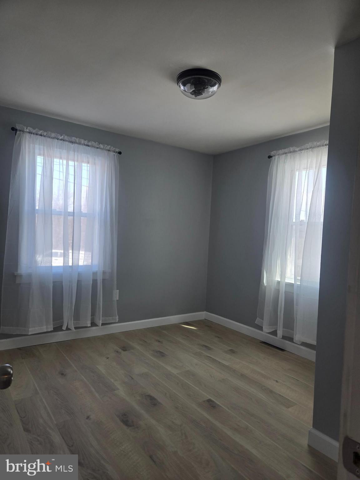 975 Williams Street Cumberland, MD 21502 - Photo 6 of 33 an empty room with wooden floor and windows