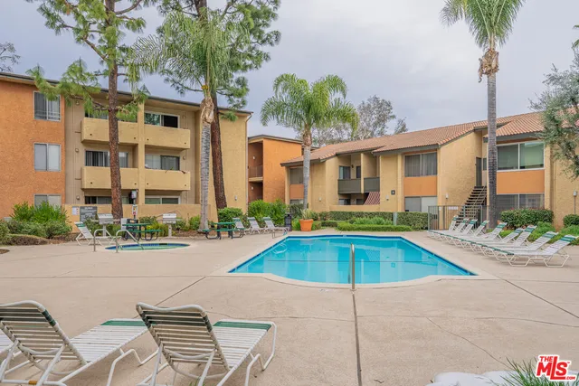 a view of a house with swimming pool and sitting area