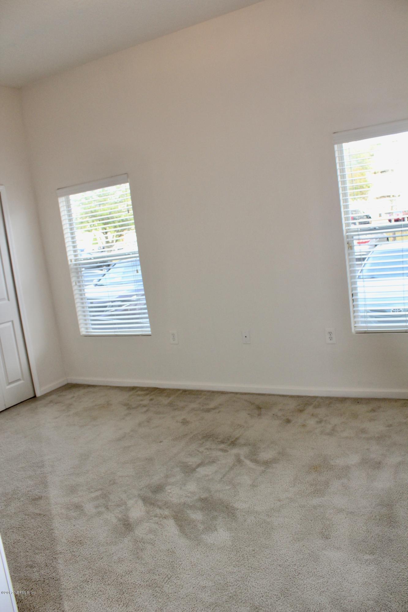 7920 Merrill Road, Unit 1705 Jacksonville, FL 32277 - Photo 12 of 25 an empty room with windows