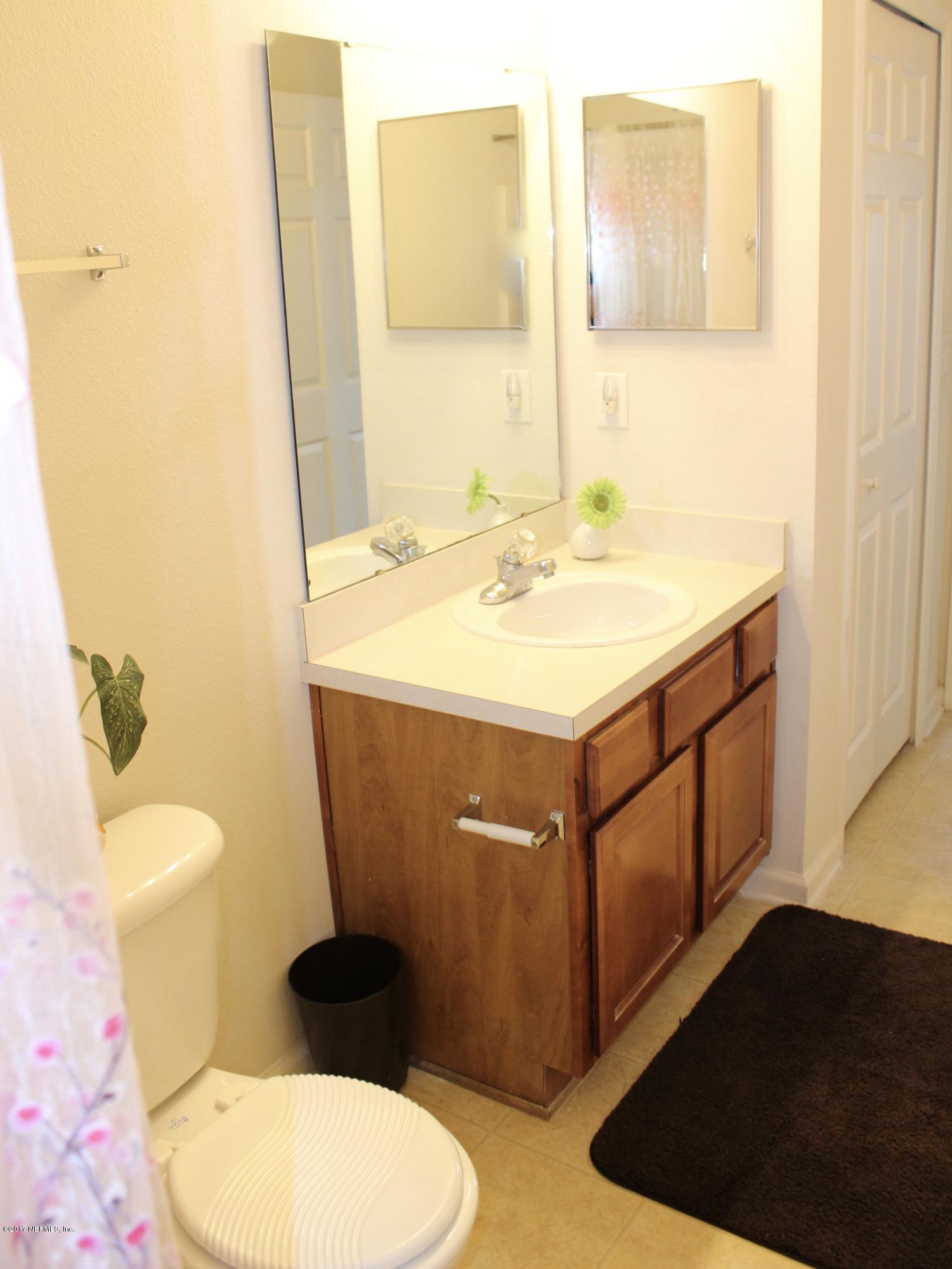 7920 Merrill Road, Unit 1705 Jacksonville, FL 32277 - Photo 14 of 25 a bathroom with a sink toilet and mirror