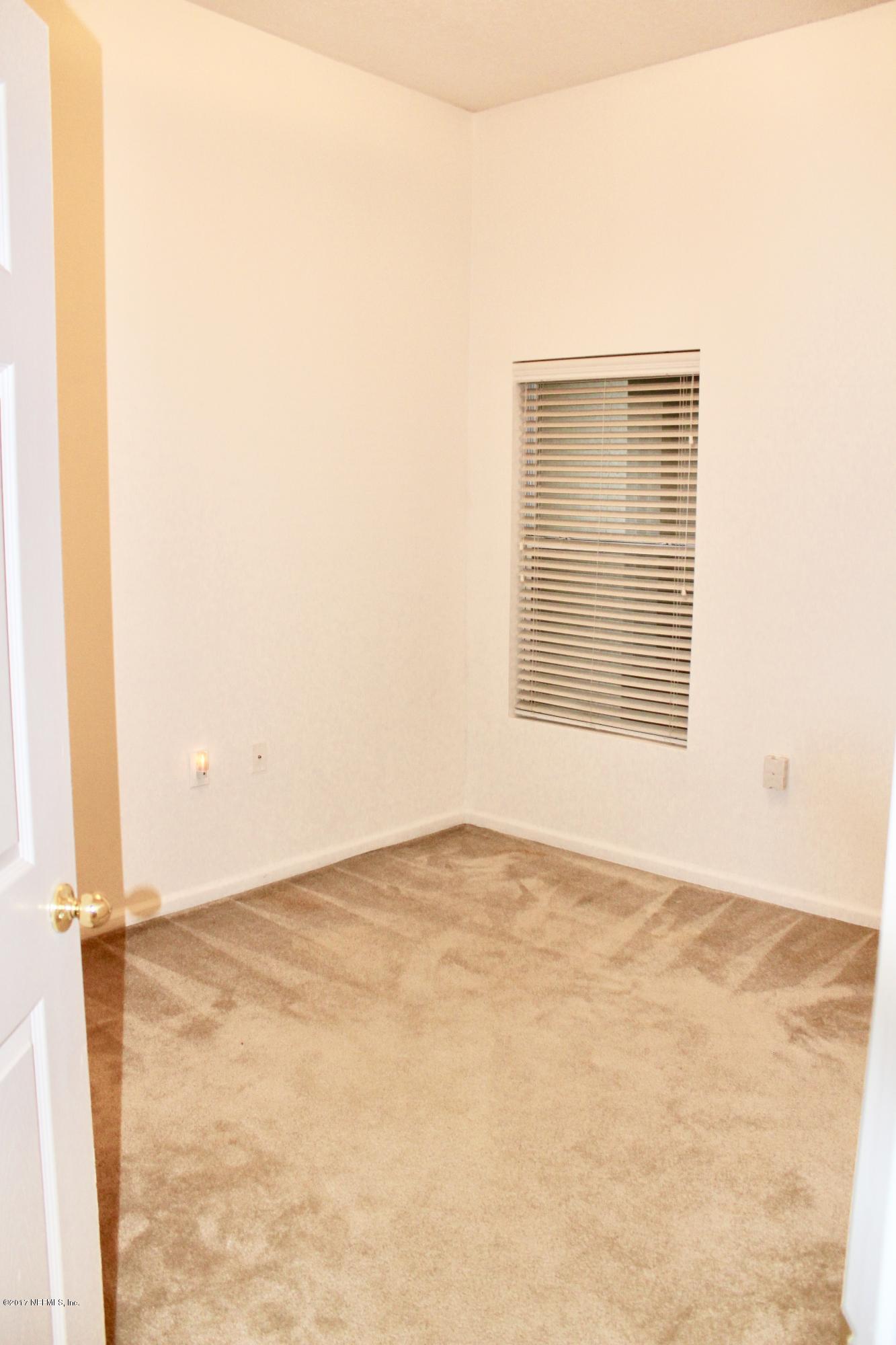 7920 Merrill Road, Unit 1705 Jacksonville, FL 32277 - Photo 15 of 25 a view of an empty room with a window