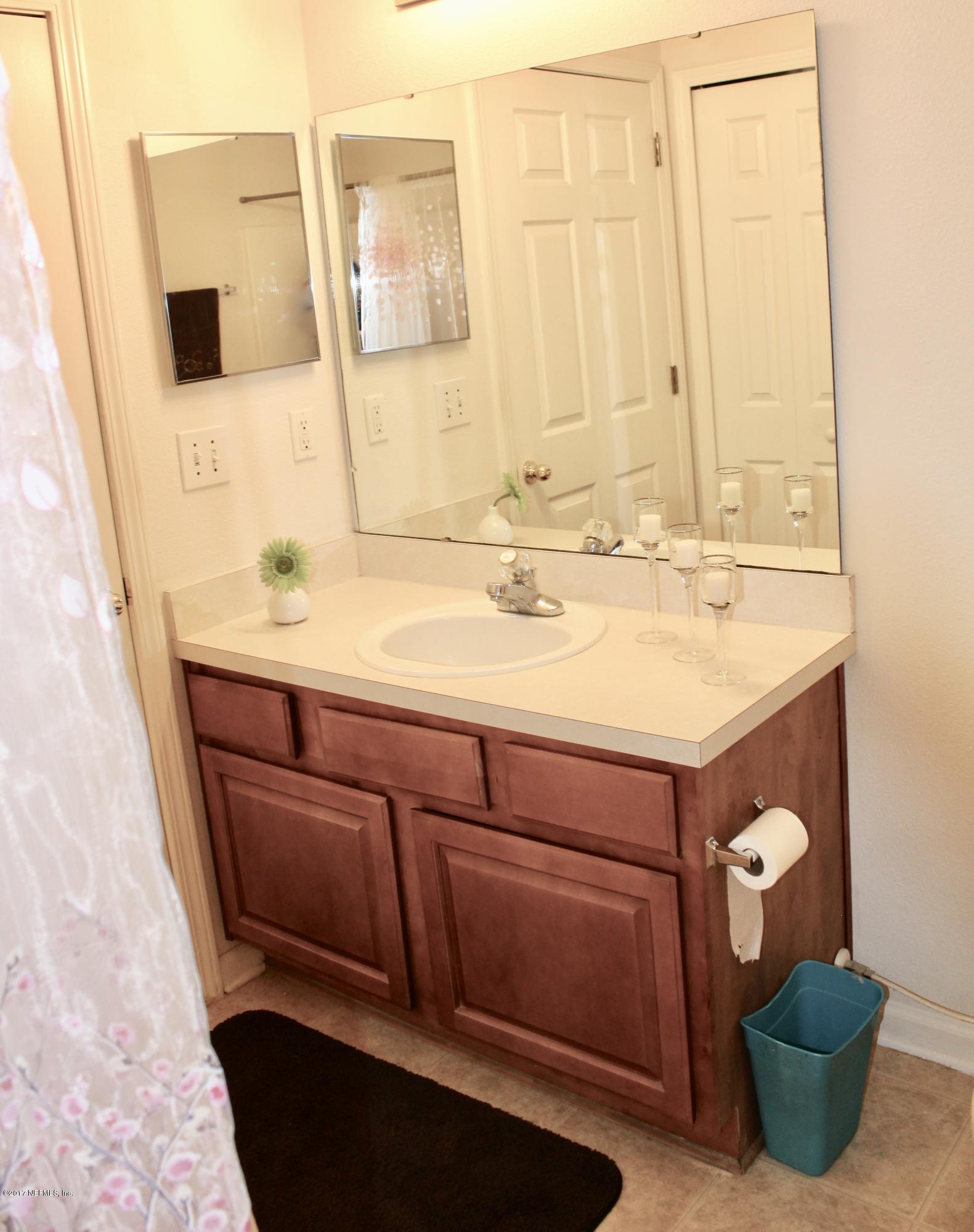 7920 Merrill Road, Unit 1705 Jacksonville, FL 32277 - Photo 17 of 25 a bathroom with a sink and a mirror