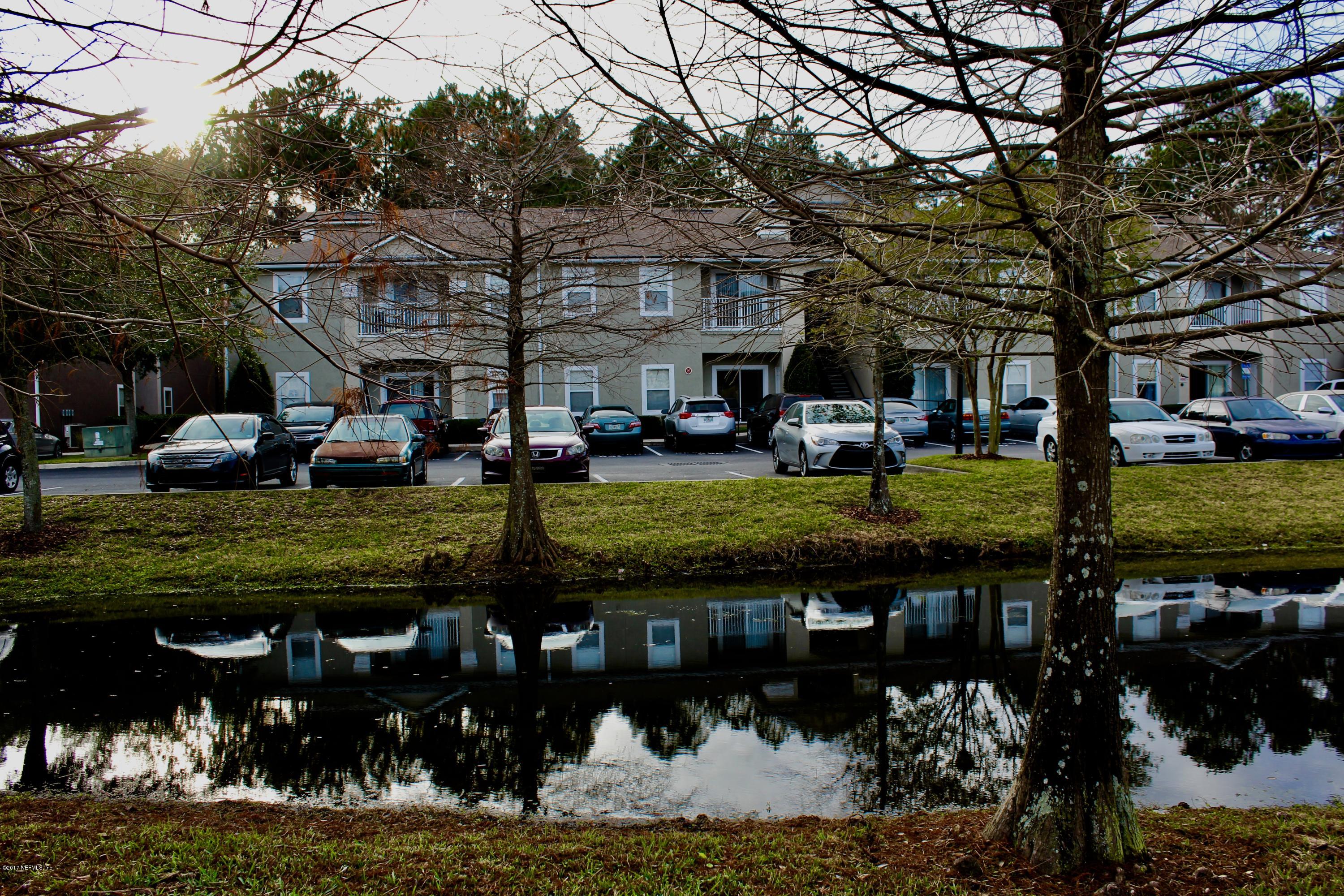 7920 Merrill Road, Unit 1705 Jacksonville, FL 32277 - Photo 23 of 25 a front view of a building with garden