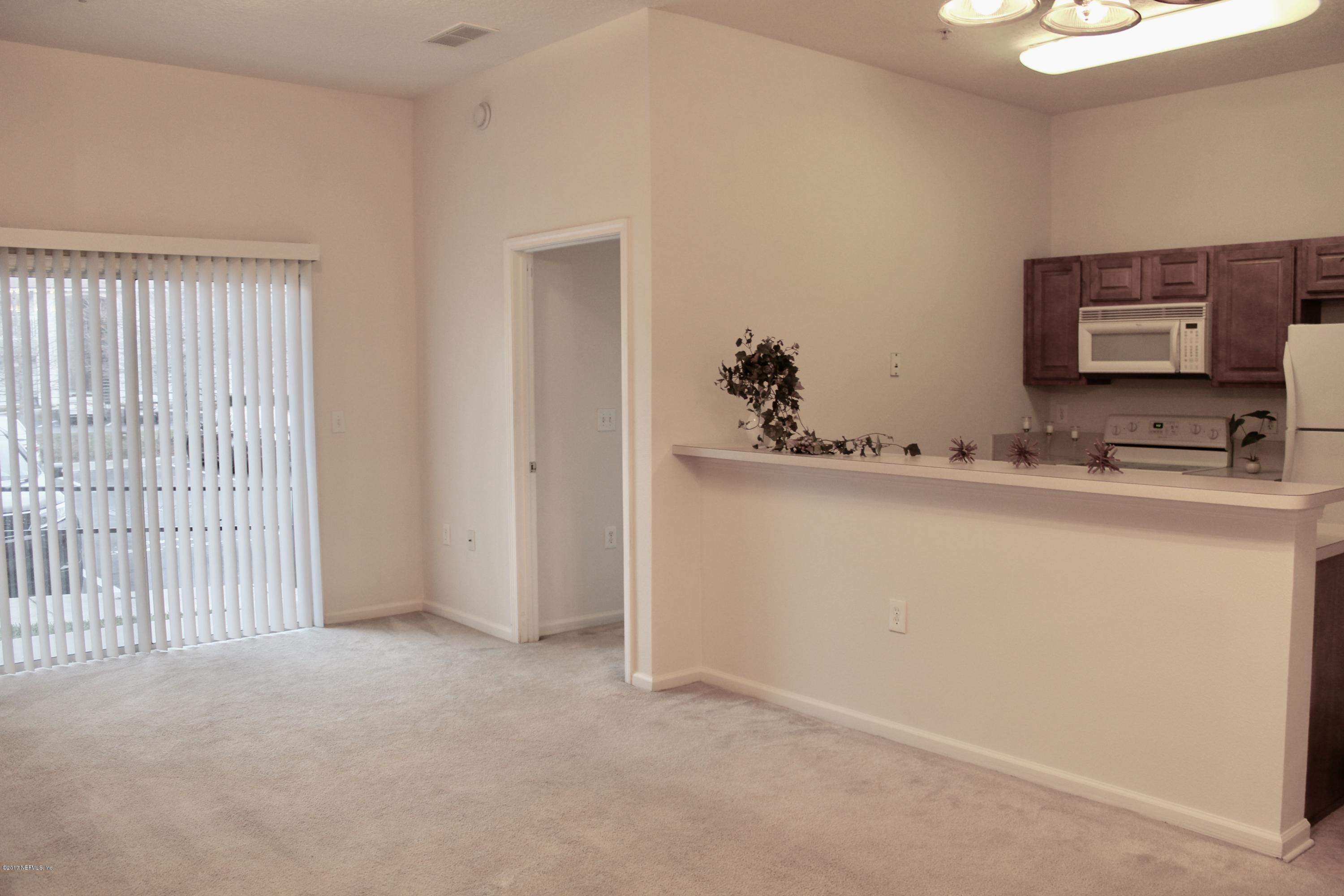 7920 Merrill Road, Unit 1705 Jacksonville, FL 32277 - Photo 3 of 25 a room with a sink and a mirror
