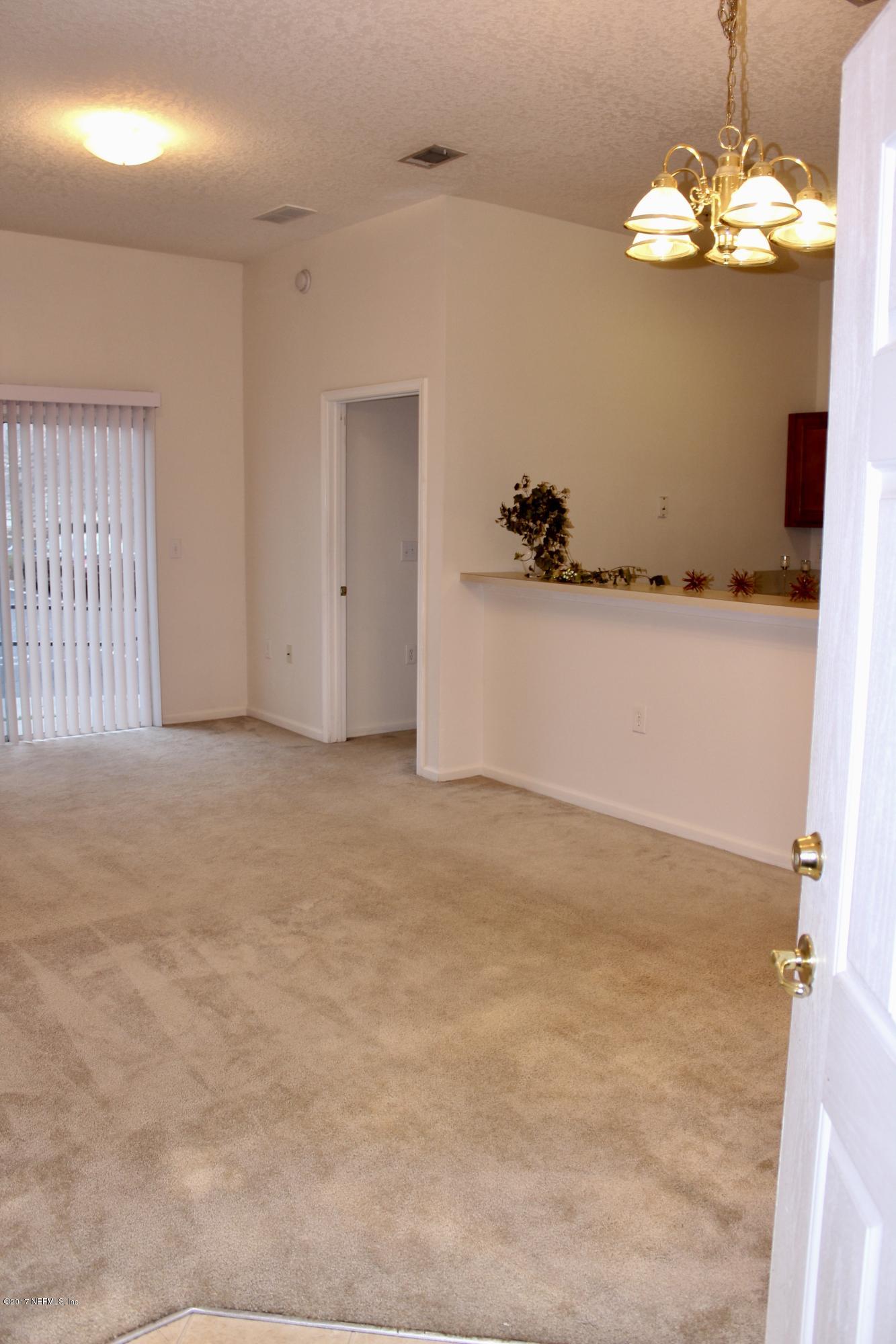 7920 Merrill Road, Unit 1705 Jacksonville, FL 32277 - Photo 5 of 25 a view of a livingroom with a chandelier