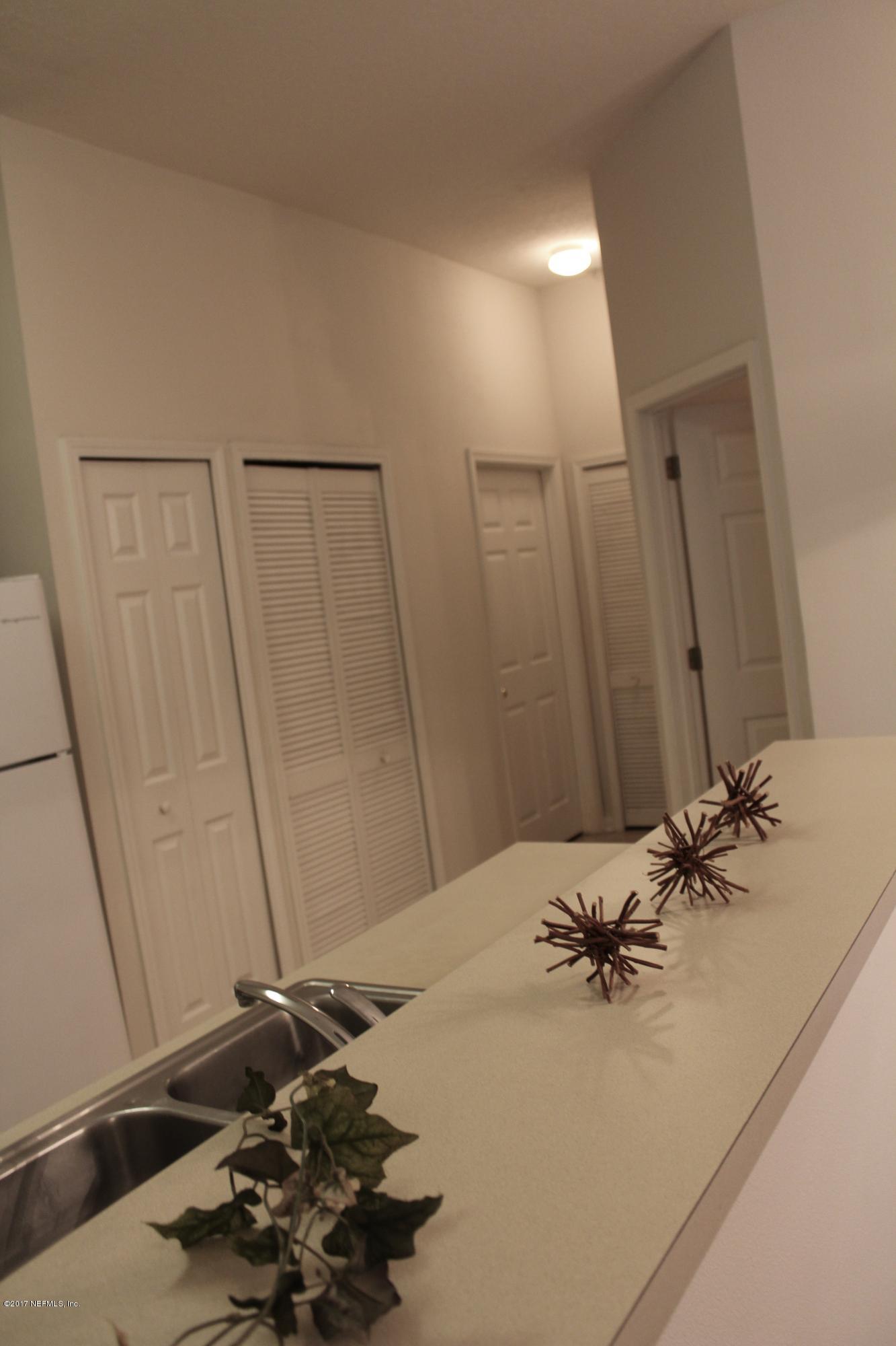 7920 Merrill Road, Unit 1705 Jacksonville, FL 32277 - Photo 6 of 25 a bathroom with a sink and a mirror