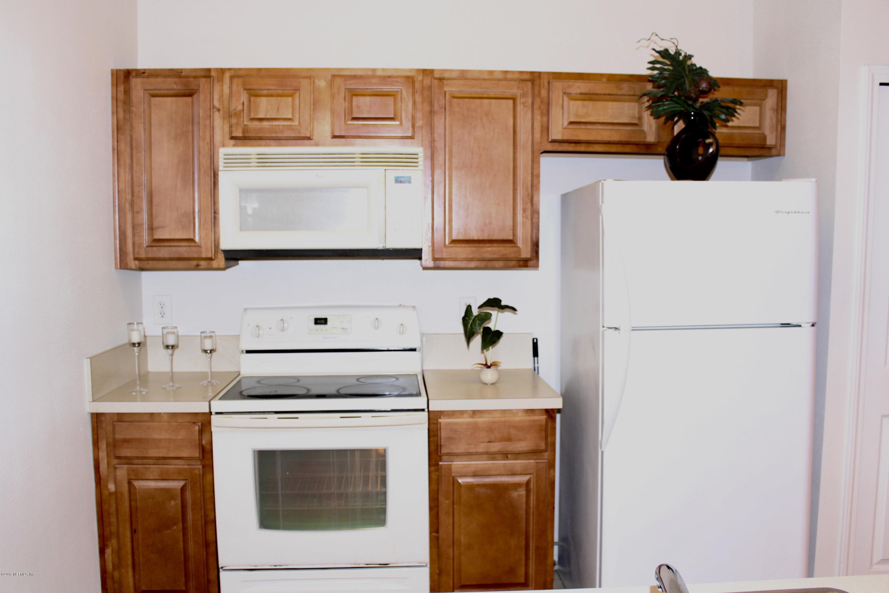 7920 Merrill Road, Unit 1705 Jacksonville, FL 32277 - Photo 8 of 25 a kitchen with a refrigerator and a stove