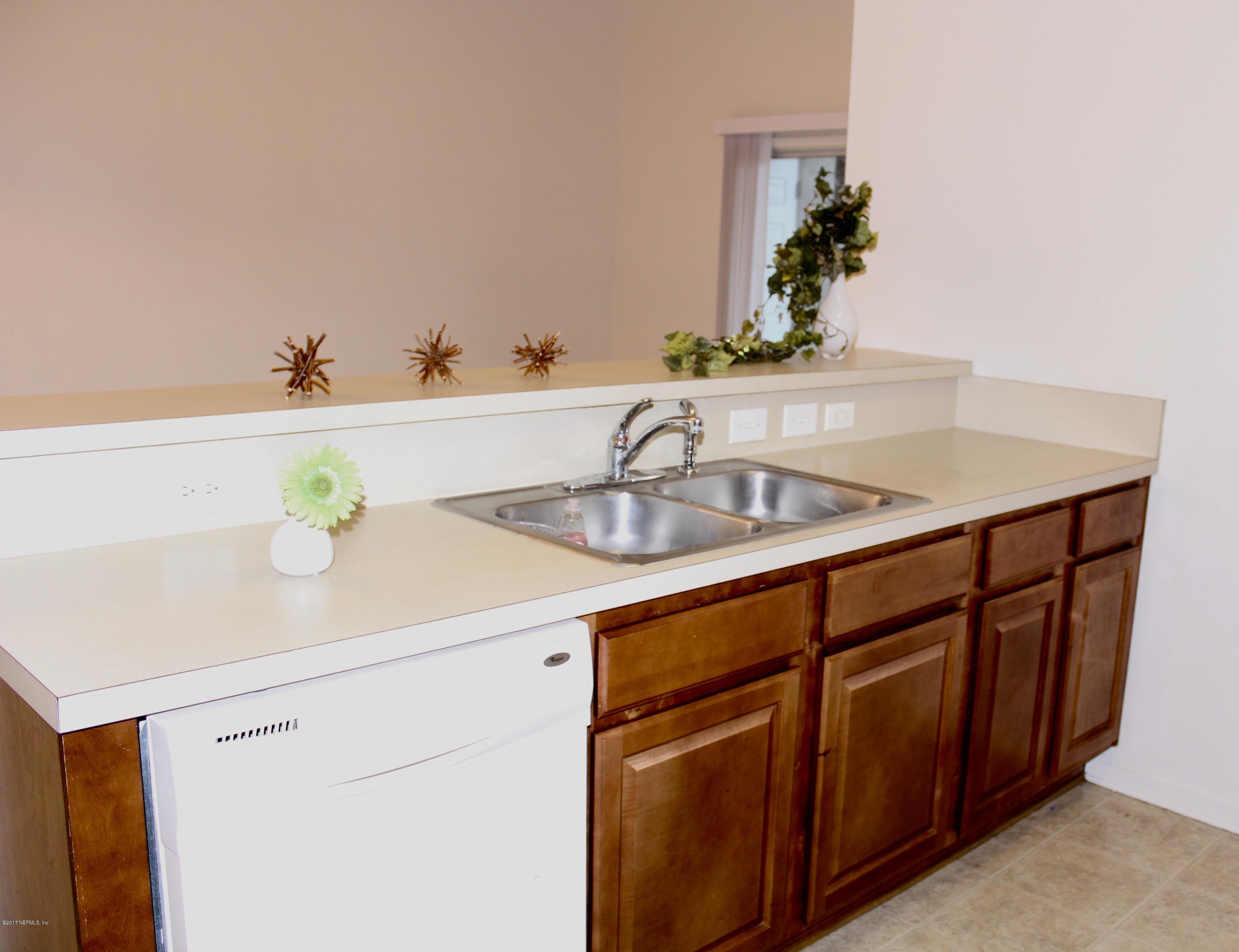 7920 Merrill Road, Unit 1705 Jacksonville, FL 32277 - Photo 9 of 25 a bathroom with a sink and a mirror