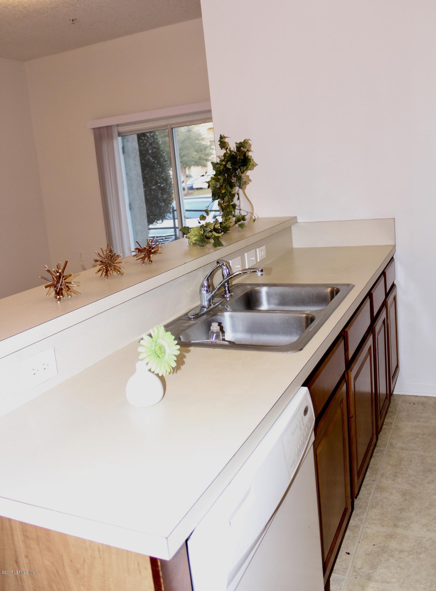 7920 Merrill Road, Unit 1705 Jacksonville, FL 32277 - Photo 10 of 25 a bathroom with a sink and a mirror