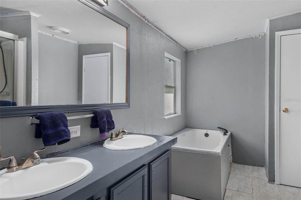 460 Korbus Road Brooksville, FL 34604 - Photo 14 of 22 a bathroom with a granite countertop sink and a mirror