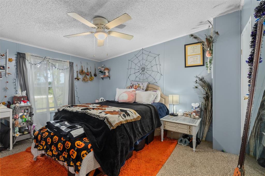 460 Korbus Road Brooksville, FL 34604 - Photo 17 of 22 a bedroom with a bed and a chandelier