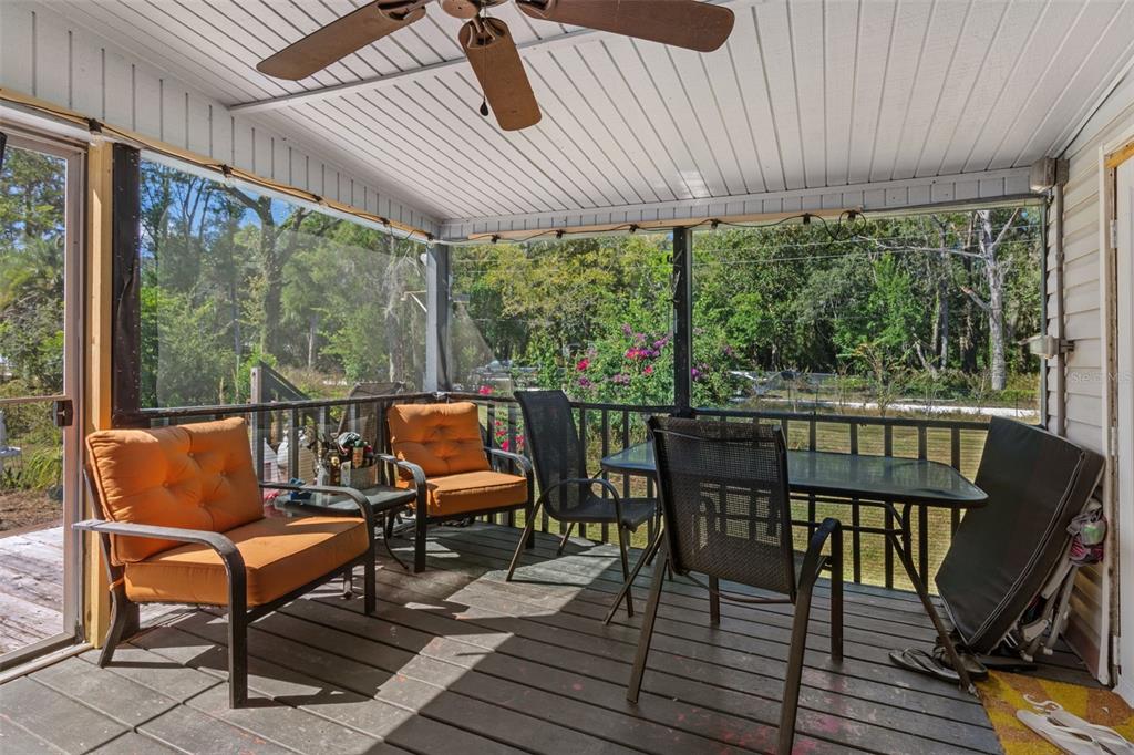 460 Korbus Road Brooksville, FL 34604 - Photo 20 of 22 a view of a chairs and table in patio with wooden floor