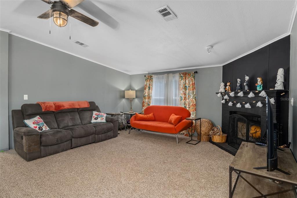 460 Korbus Road Brooksville, FL 34604 - Photo 5 of 22 a living room with furniture a couch and a fireplace