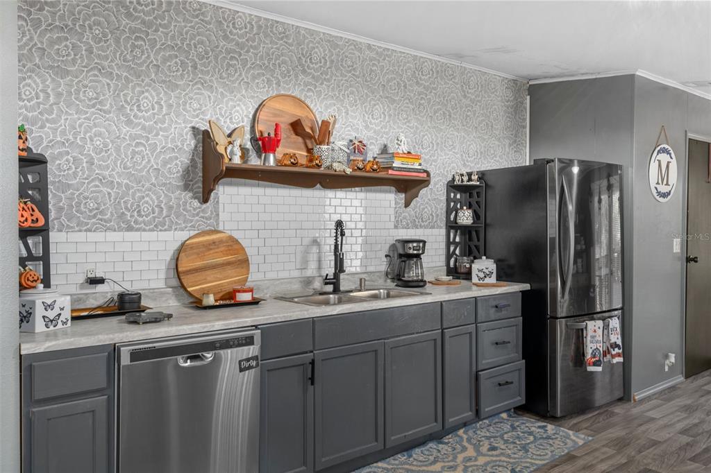 460 Korbus Road Brooksville, FL 34604 - Photo 9 of 22 a kitchen with sink a refrigerator and cabinets