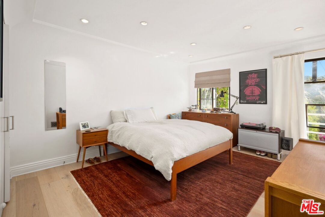 232 South Rodeo Drive Beverly Hills, CA 90212 - Photo 11 of 14 a bedroom with a bed and wooden floor