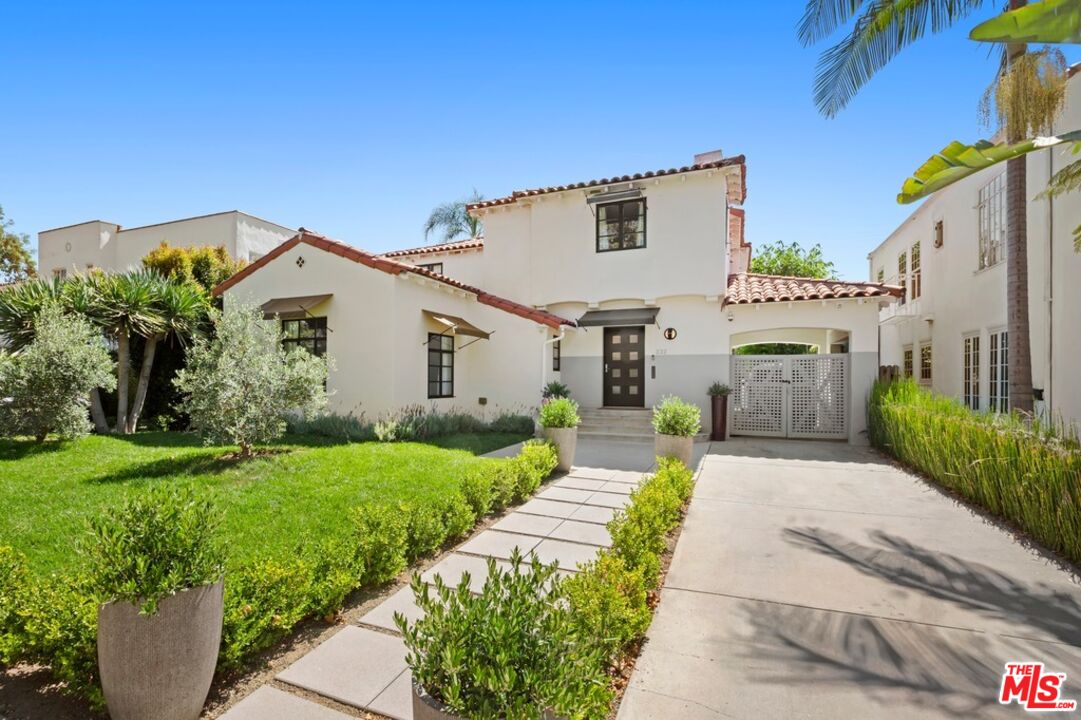 232 South Rodeo Drive Beverly Hills, CA 90212 - Photo 14 of 14 a front view of a house with a garden and pathway