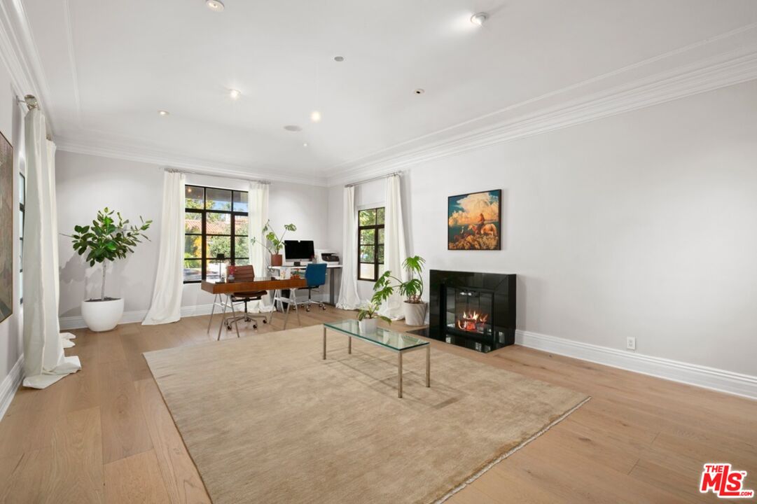 232 South Rodeo Drive Beverly Hills, CA 90212 - Photo 2 of 14 a living room with furniture and a fireplace