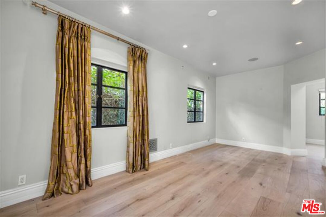 232 South Rodeo Drive Beverly Hills, CA 90212 - Photo 4 of 14 an empty room with wooden floor and a window