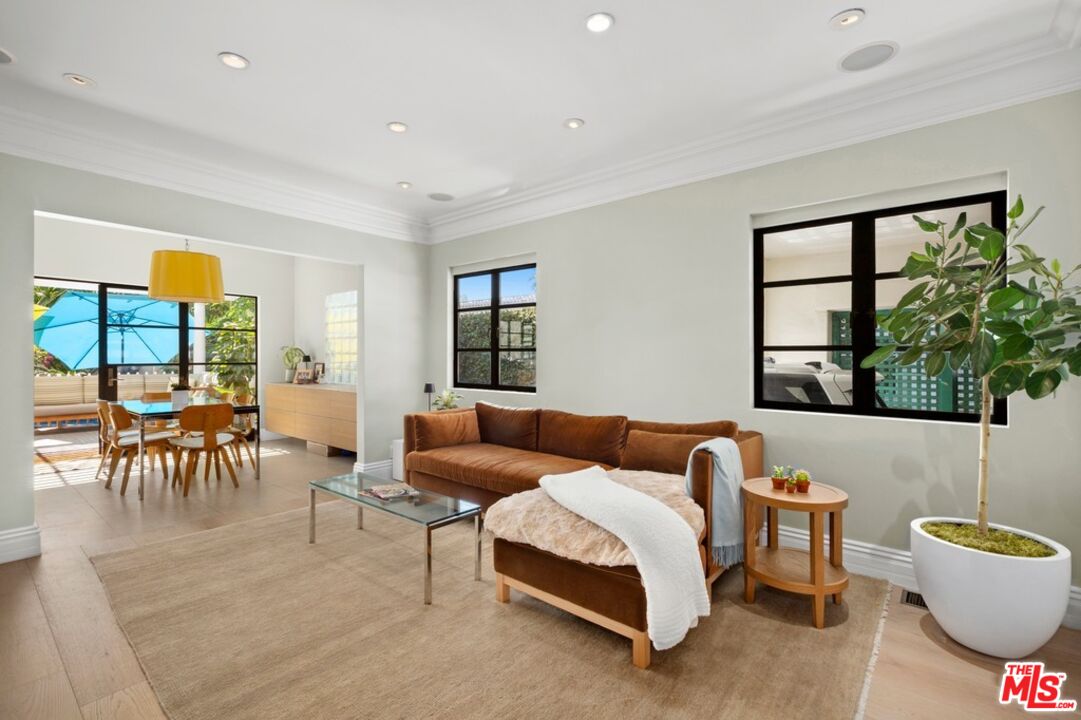 232 South Rodeo Drive Beverly Hills, CA 90212 - Photo 5 of 14 a living room with furniture and a large window