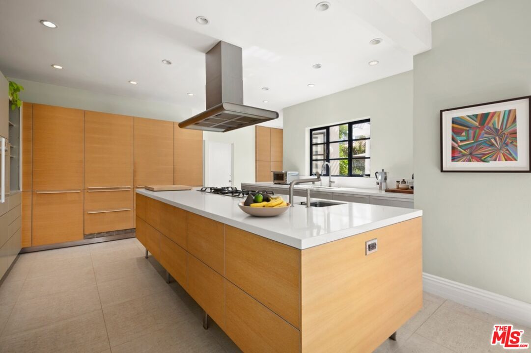 232 South Rodeo Drive Beverly Hills, CA 90212 - Photo 8 of 14 a kitchen with stainless steel appliances a sink stove and cabinets