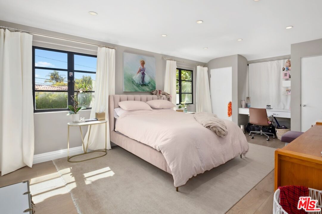 232 South Rodeo Drive Beverly Hills, CA 90212 - Photo 9 of 14 a spacious bedroom with a bed a table and large window