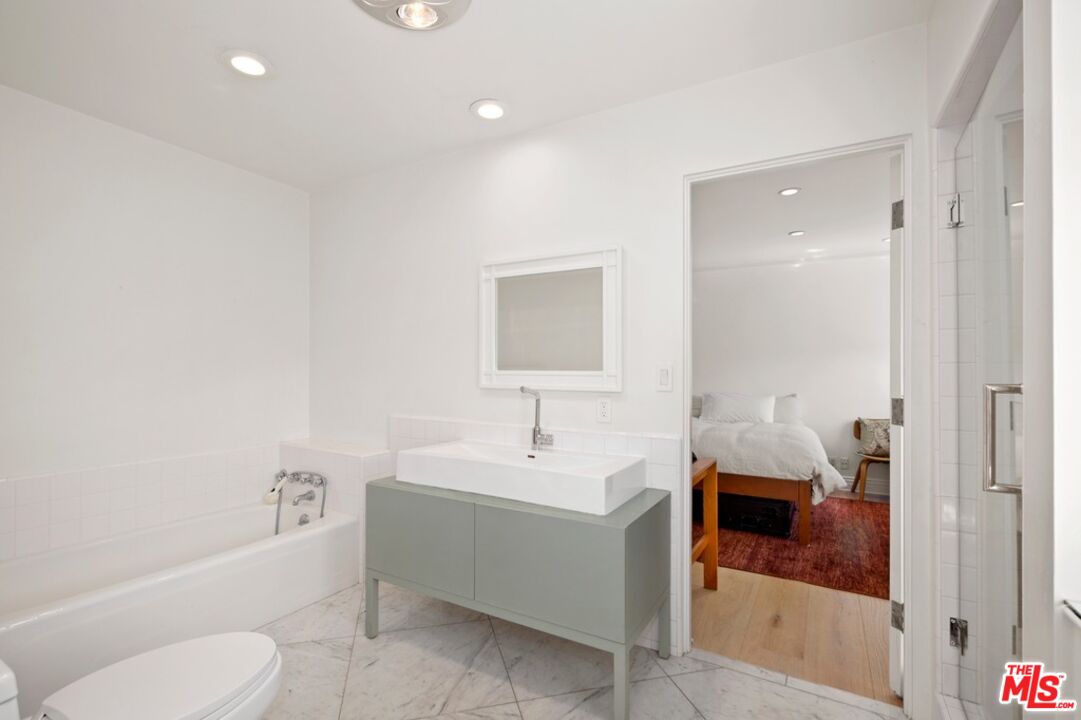 232 South Rodeo Drive Beverly Hills, CA 90212 - Photo 10 of 14 a bathroom with a sink toilet and shower