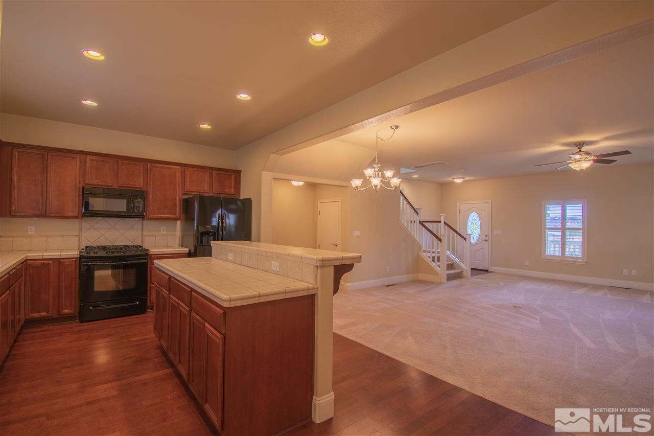 1350 Waterloo Drive Reno, NV 89509 - Photo 6 of 19 a kitchen with stainless steel appliances granite countertop a sink a stove and a refrigerator