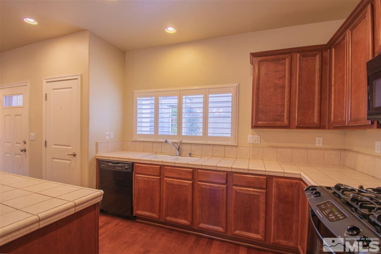 1350 Waterloo Drive Reno, NV 89509 - Photo 7 of 19 a kitchen with a sink and wooden cabinets