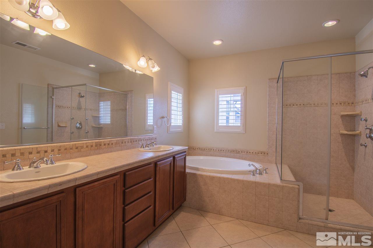 1350 Waterloo Drive Reno, NV 89509 - Photo 10 of 19 a bathroom with a tub a sink shower and mirror
