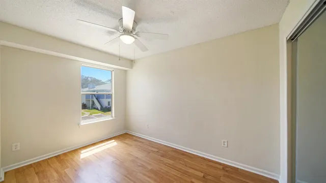 wooden floor in an empty room with a window