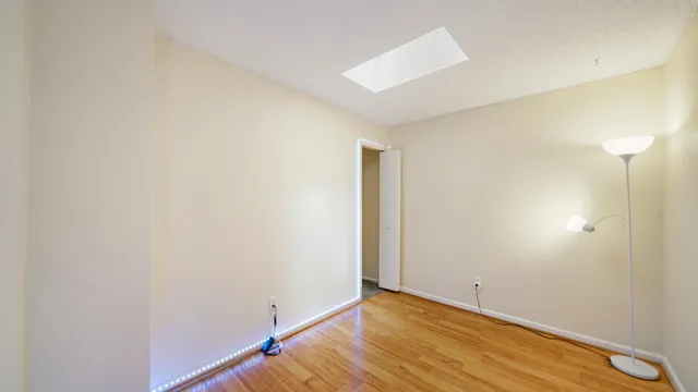 an empty room with windows and fan